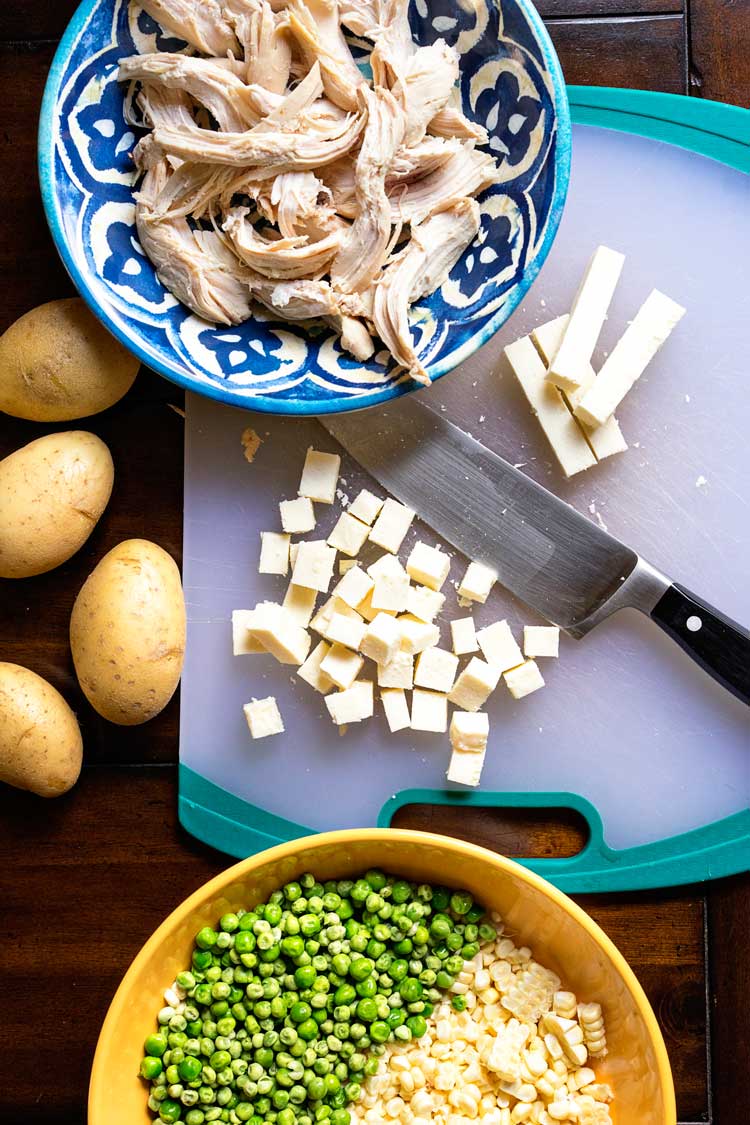 shredded chicken in a bowl and some potatoes