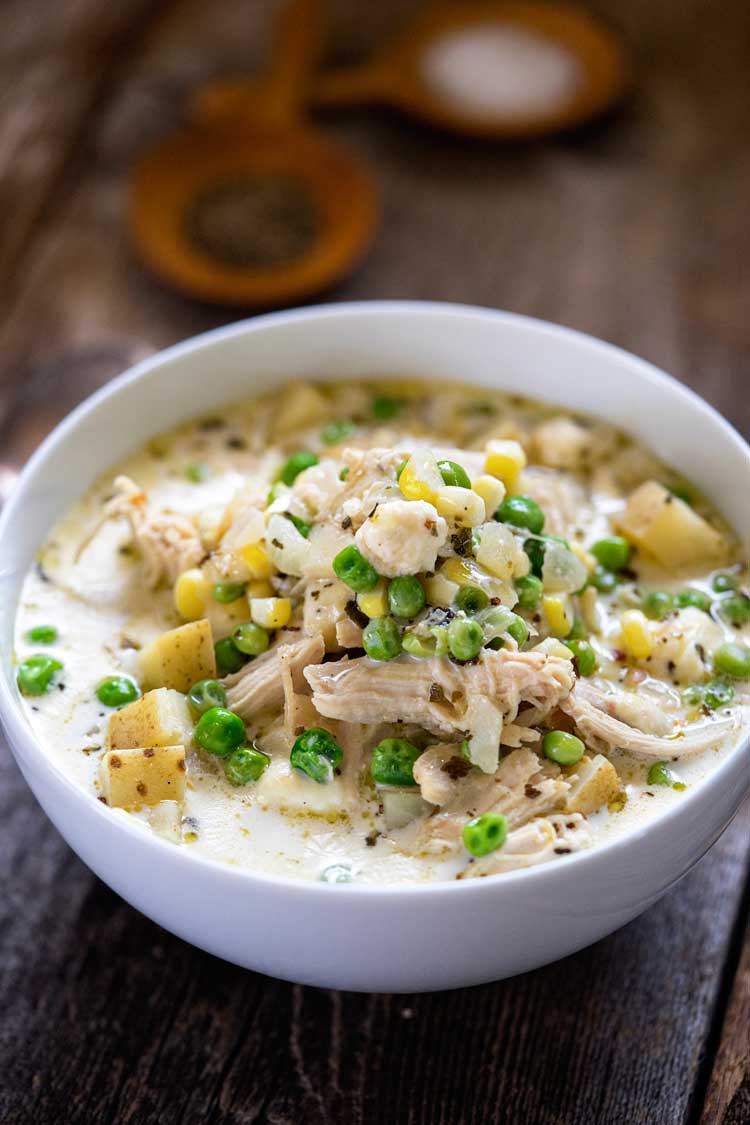 white bowl with creamy chicken and potato soup