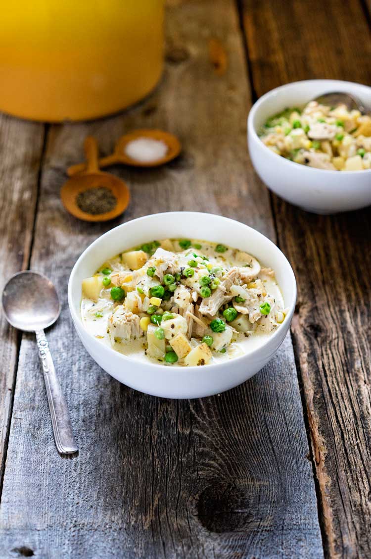 creamy chicken and potato soup in a white bowl