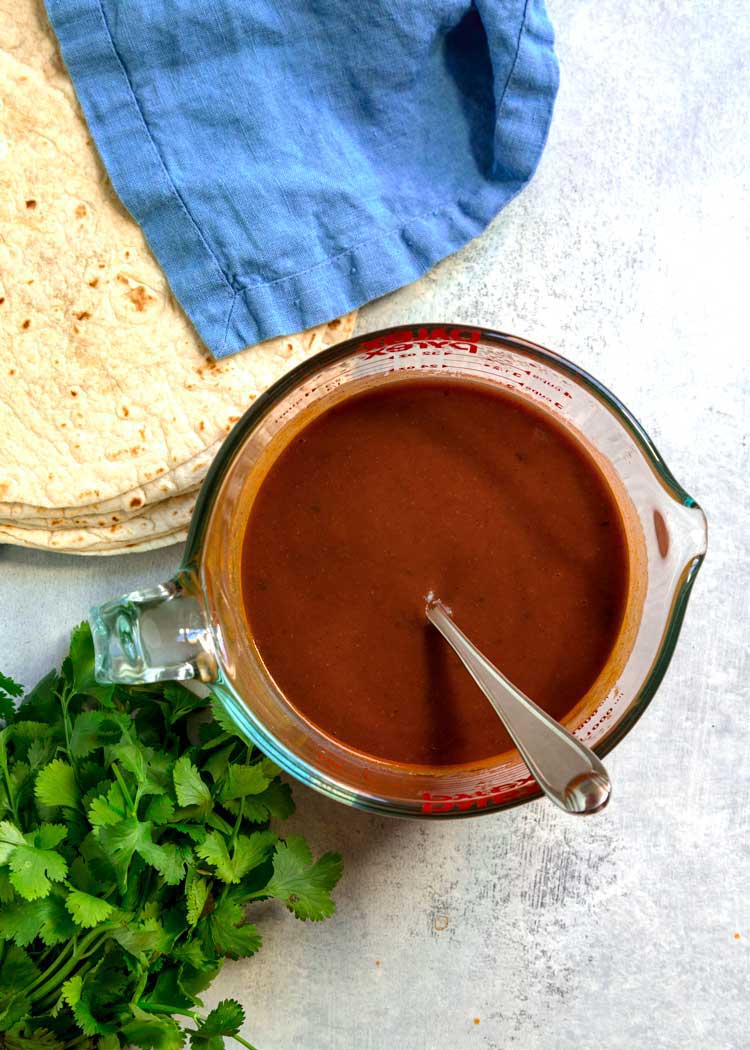 overhead shot of red sauce in glass measuring cup