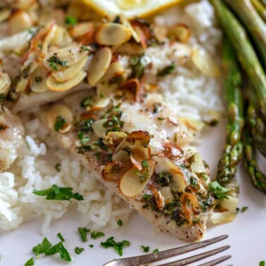 A close up of a plate of baked rockfish Almondine