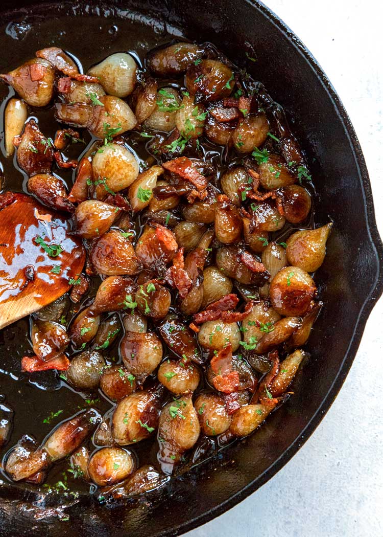 overhead: pearl onion recipe cooking in a skillet with bacon