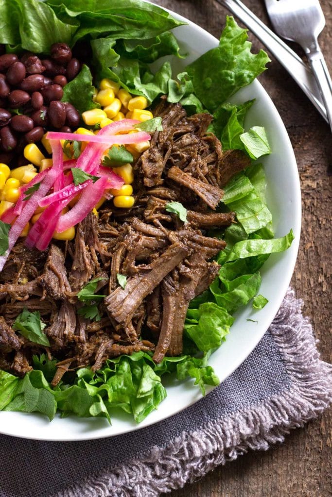 overhead: burrito bowl with shredded beef and vegetables