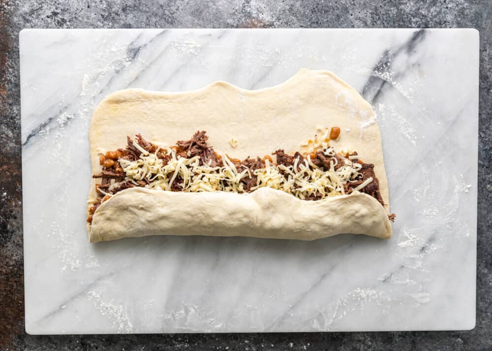 rolling dough to make bbq beef rolls