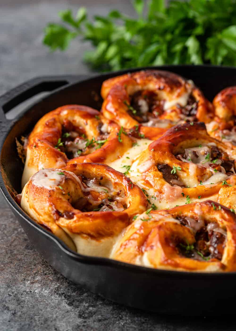 side view of bbq beef rolls in skillet