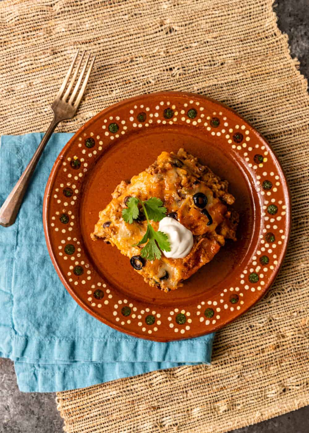 overhead: serving of layered enchilada casserole on plate