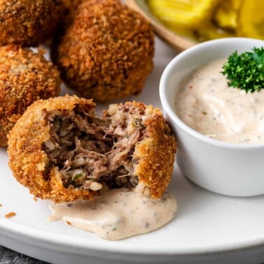 fried Louisiana boudin sausage balls on platter with Cajun dipping sauce