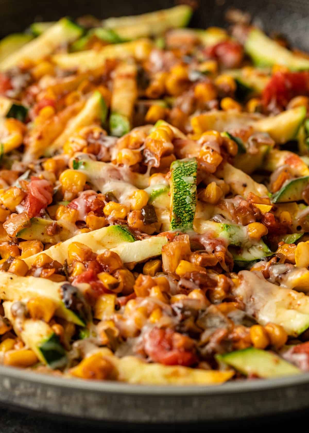 extreme closeup: calabacitas recipe in a skillet with cheese