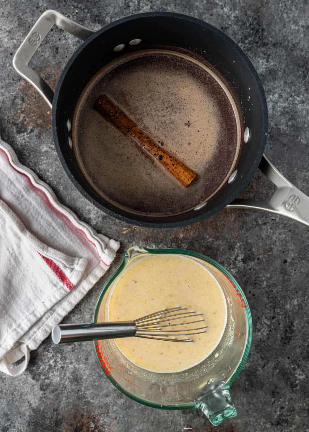 overhead: whole cinnamon stick in saucepan of hot water