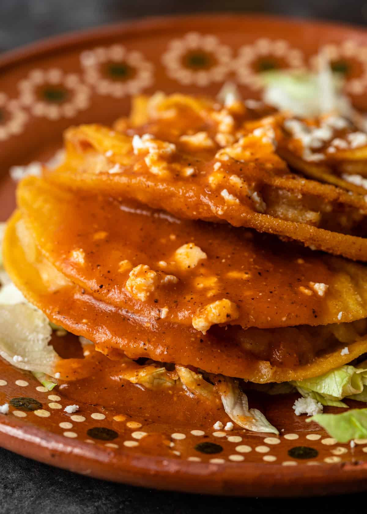 extreme closeup: potato taco recipe covered in sauce on a ceramic plate