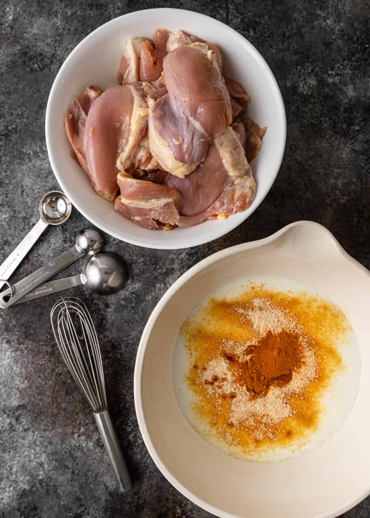 chicken thighs in a bowl for chicken and waffles