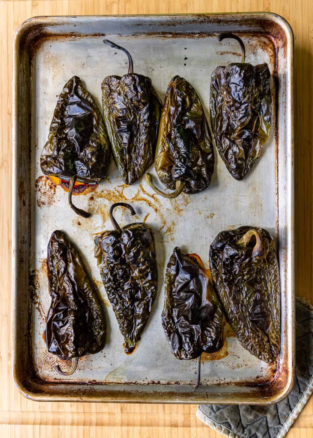 roasted poblanos on baking sheet