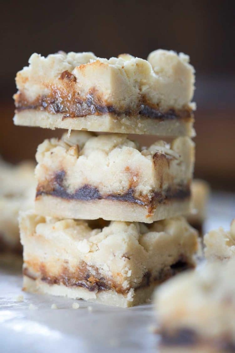 A family favorite! These Caramel Butter Bars are a buttery shortbread bar cookie with chocolate and caramel. The crumble topping with slivered almonds covers the decadent filling. So good! www.keviniscooking.com