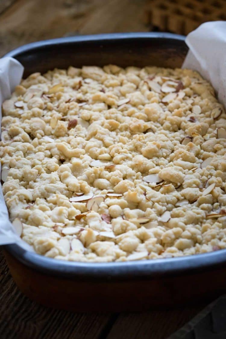 A family favorite! These Caramel Butter Bars are a buttery shortbread bar cookie with chocolate and caramel. The crumble topping with slivered almonds covers the decadent filling. So good! www.keviniscooking.com