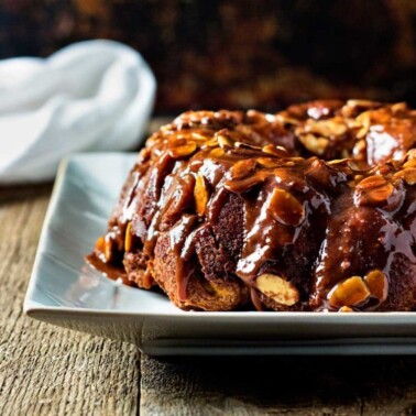 This Chocolate Caramel Monkey Bread is made with refrigerated biscuit dough and few pantry ingredients, Wrap, dunk, roll and bake - you're set! www.keviniscooking.com