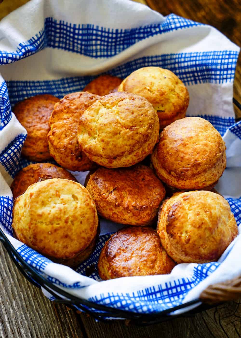 overhead: homemade biscuits from scratch in linen napkin lined basket