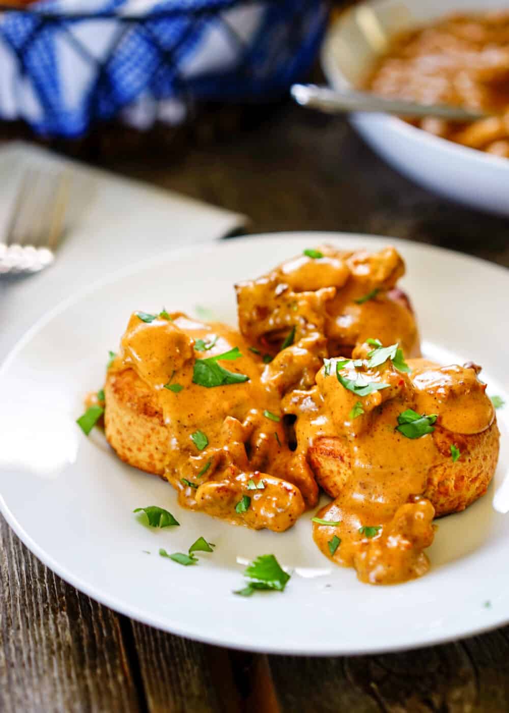 chorizo gravy ladled over cheese biscuits