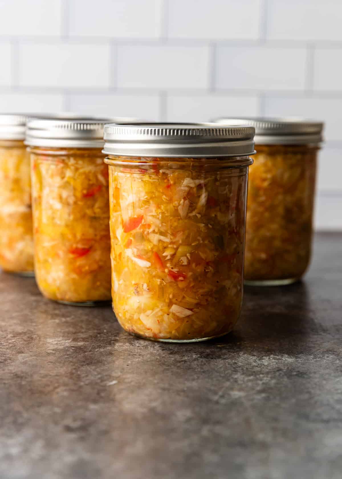 side view: several jars full of Chow Chow relish recipe