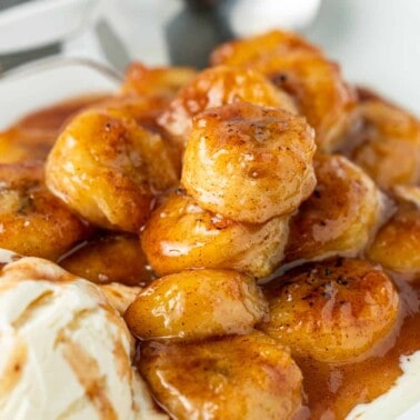 close up: bowl of warm cinnamon honey fried bananas with scoop of vanilla ice cream