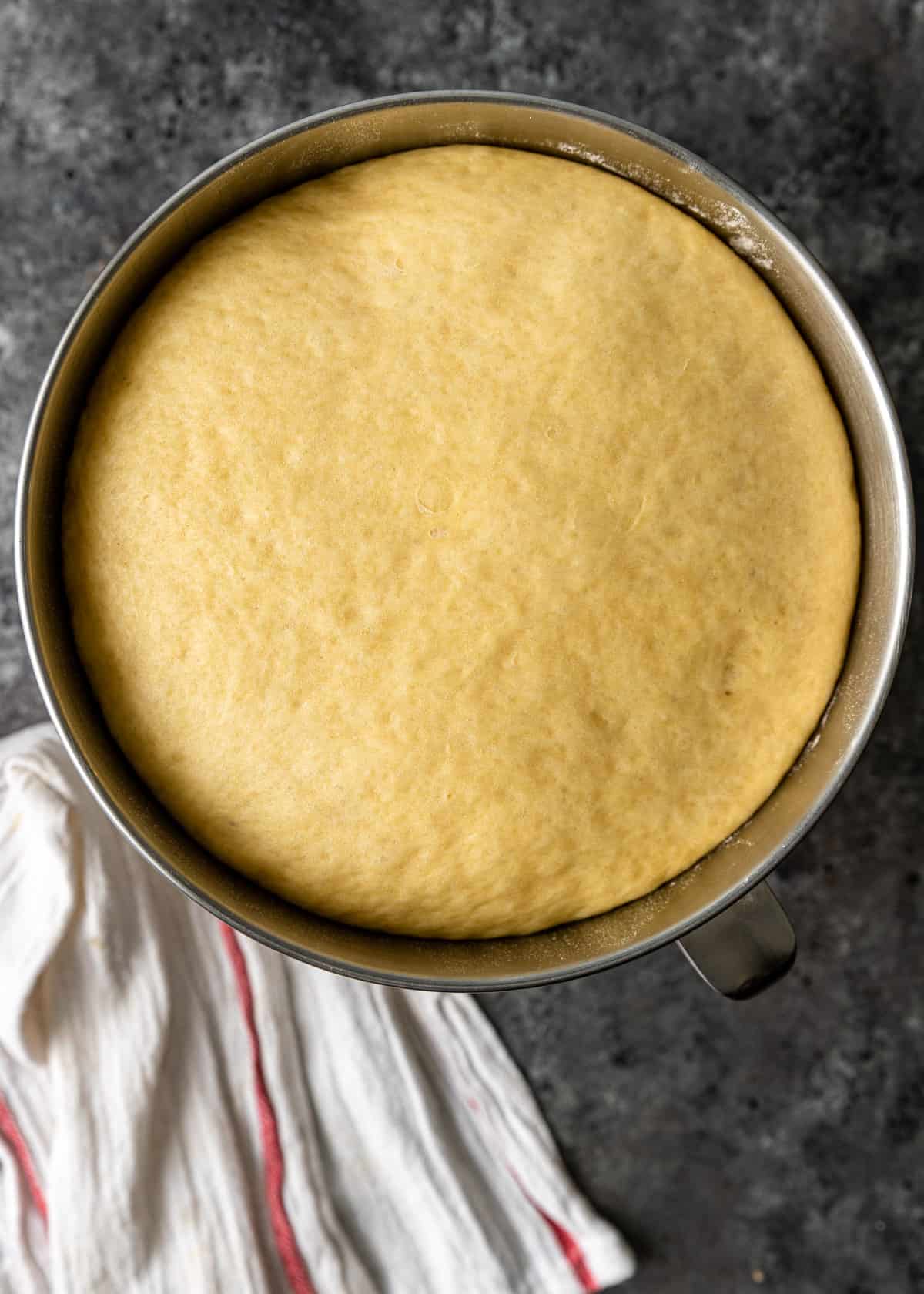 Pan dolce dough in a large metal bowl after a 2 hour rise