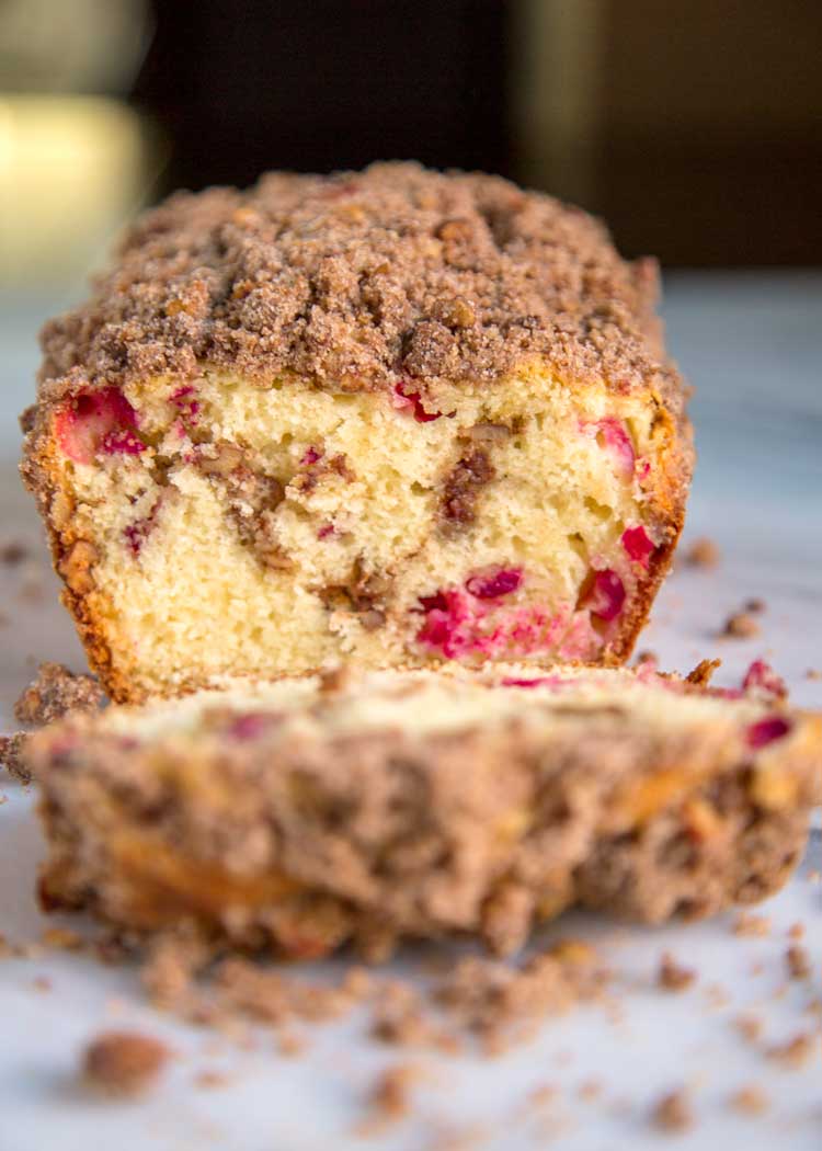 This tender Cranberry Nut Bread is the perfect way to wake up with a cup of coffee or tea. Loaded with cranberries and a crunchy cinnamon streusel topping. keviniscooking.com