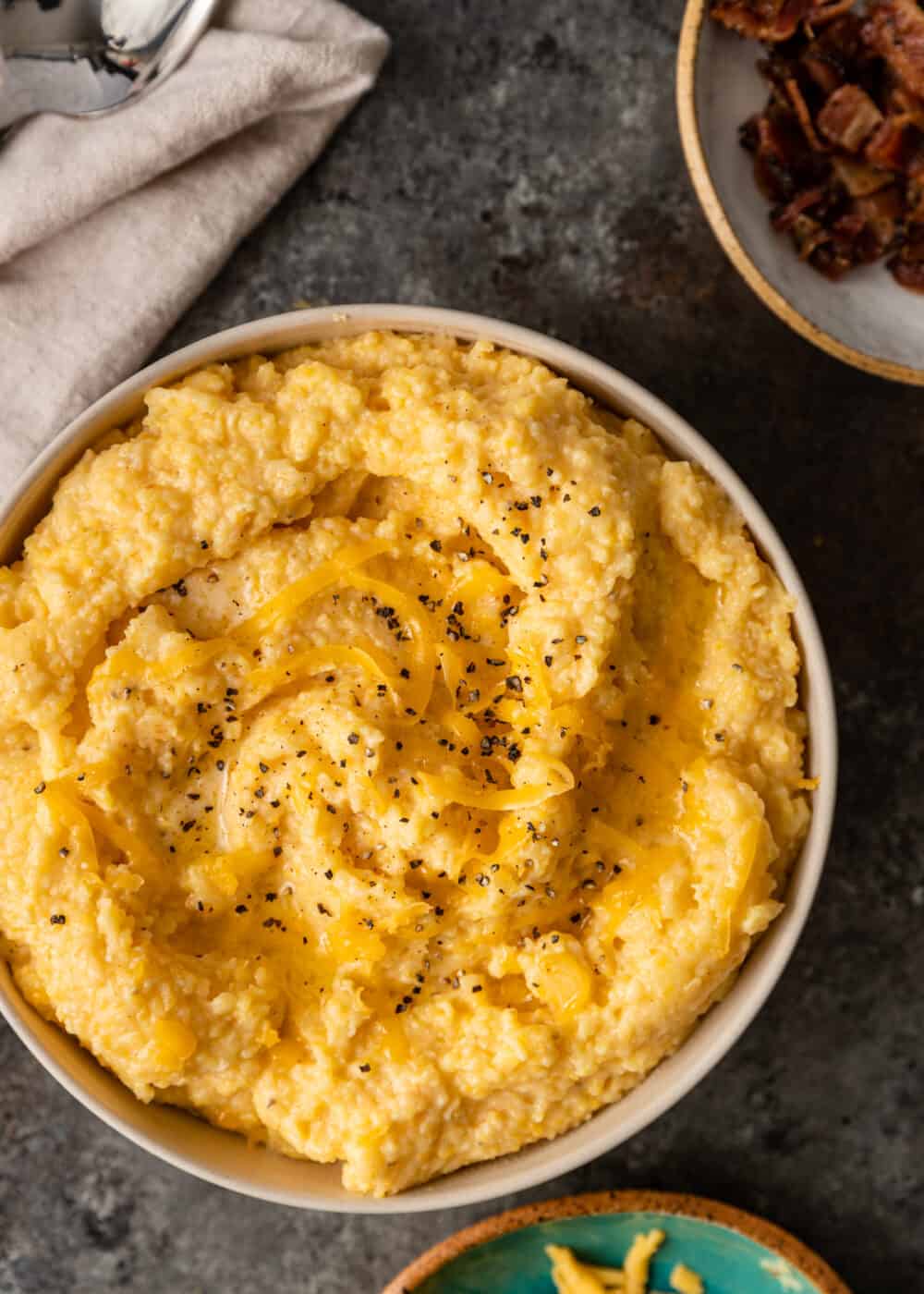 overhead: bowl of creamy hominy with cheddar cheese