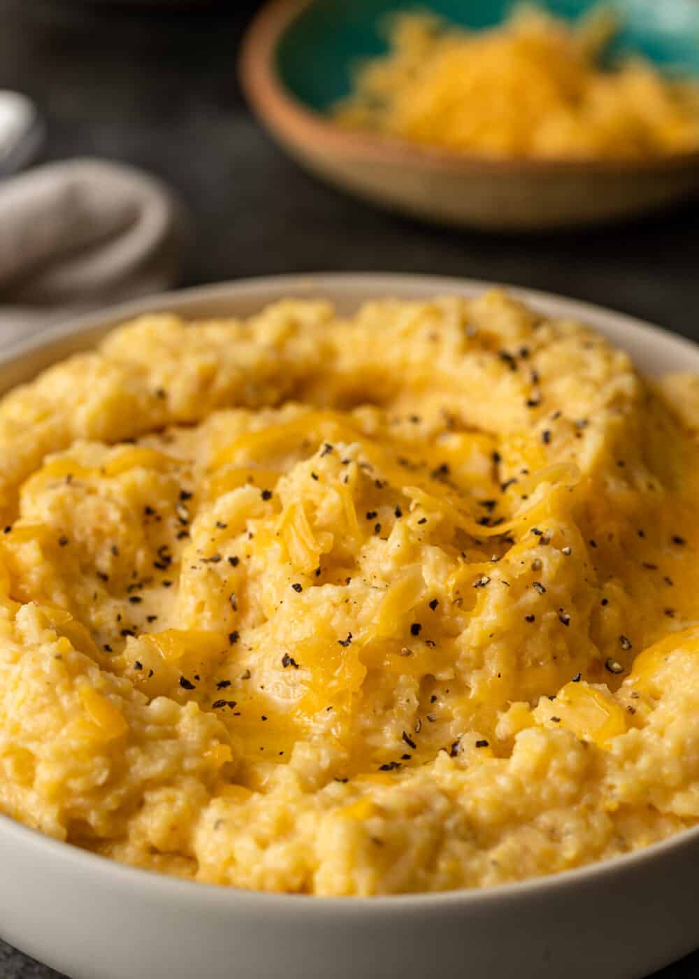 melted cheddar on hominy in bowl