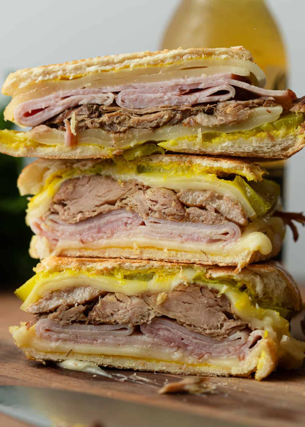 Stacks of Cuban Sandwiches on a cutting board.