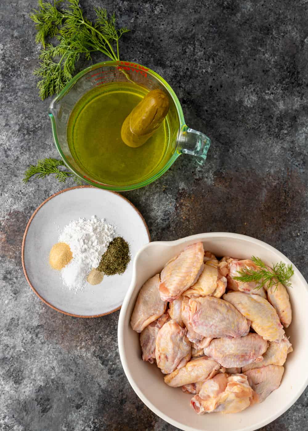 raw chicken wings, baking powder, spices, and dill pickle juice to make baked crispy chicken wings