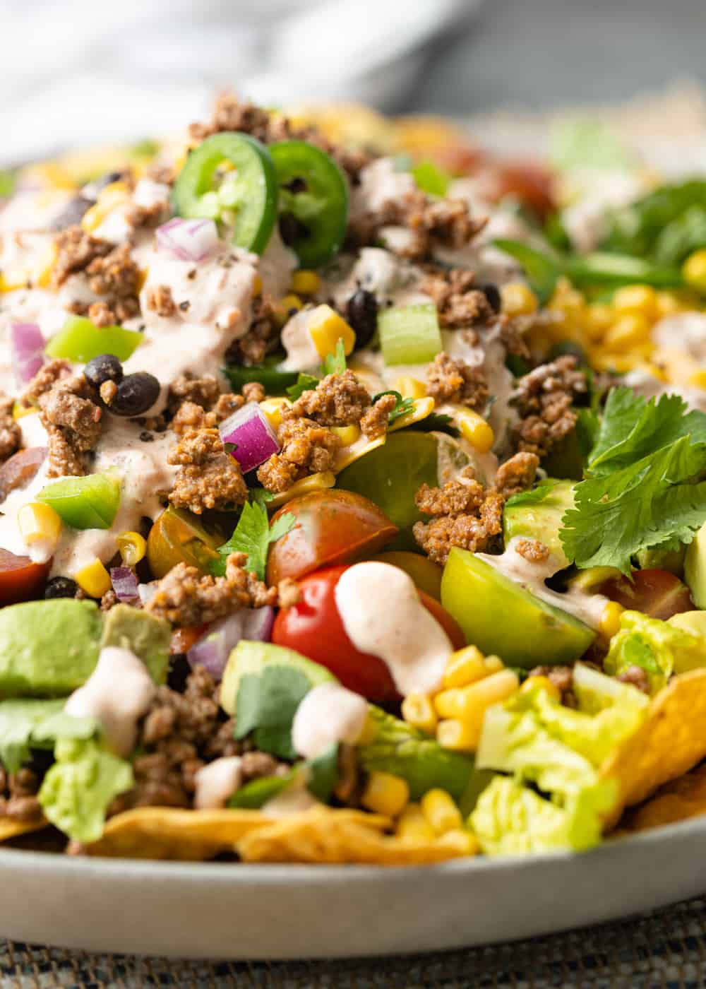 jalapeños, tomatoes, corn, avocado on romaine with taco meat and salad dressing