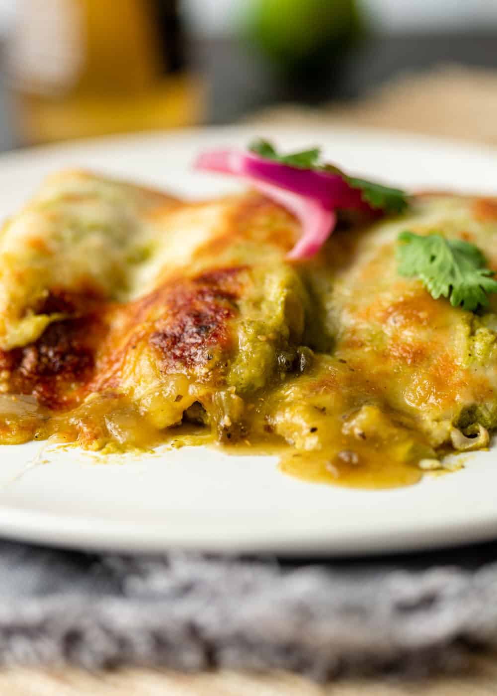 chicken enchilada suiza topped with red onion and cilantro