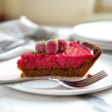 This Cranberry Lime Pie has a gingersnap cookie and walnut crust, a cranberry lime curd that is out of this world and topped with candied cranberries. Wow! keviniscooking.com