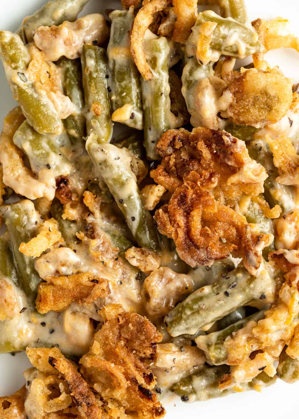 extreme closeup: french's green bean casserole with crispy onions on top