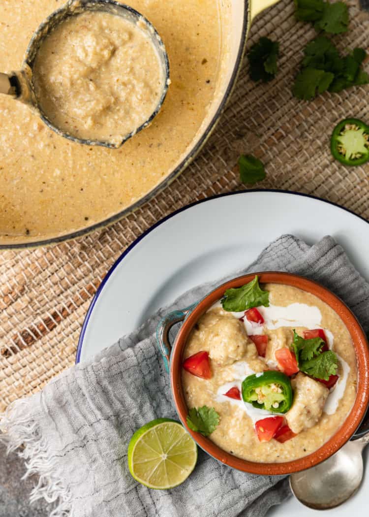 overhead: bowl of creamy soup with chicken and vegetables