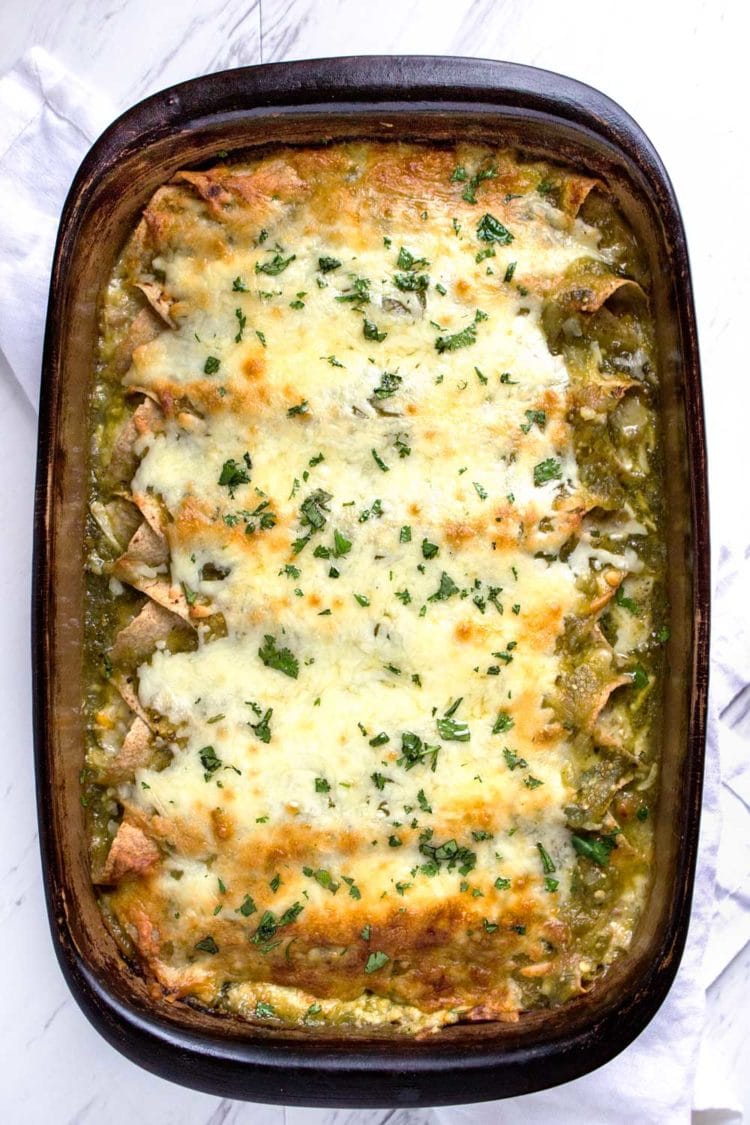 overhead: pan of green enchiladas covered with melted white cheese