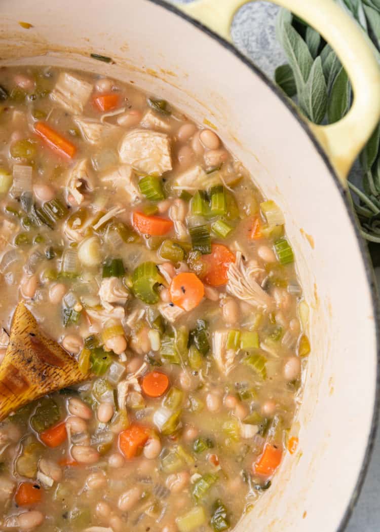 southwest chicken soup in pot with wooden spoon