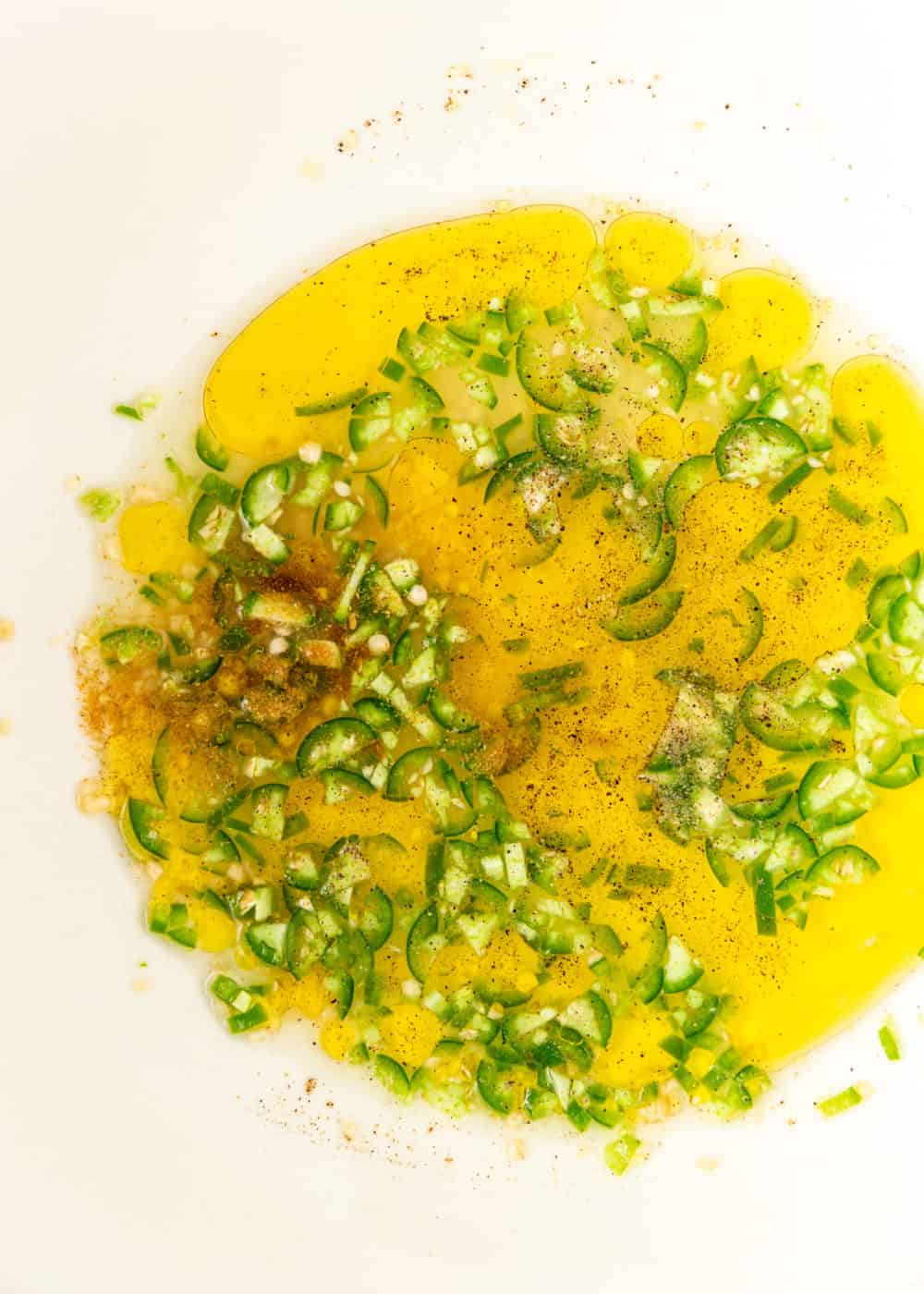 overhead close up image: bowl of green chili lime dressing