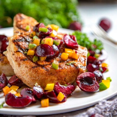 Dry rubbed grilled pork chop with fresh cherry salsa