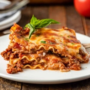 plated slice of lasagna with bechamel and bolognese sauce