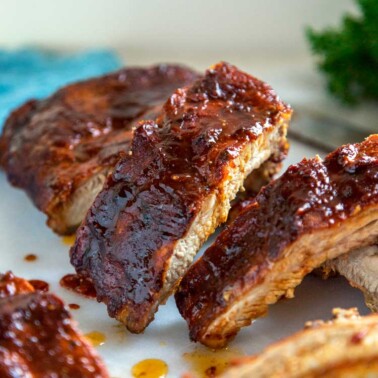 Kansas City Style Ribs are typically characterized by the thick, sticky sauce brushed on in the last 30 minutes of cooking. The dry rub and sauce are on the sweet side using a brown sugar base, but are balanced with chili powder and pepper, producing some truly finger licking good ribs.