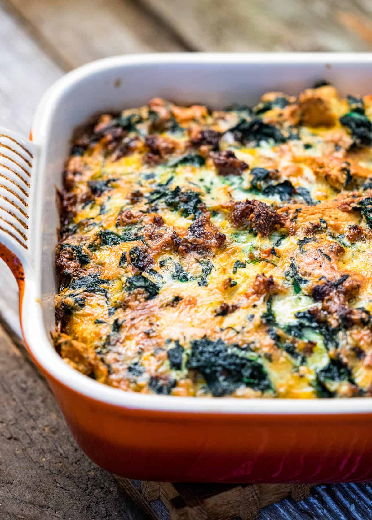 egg breakfast casserole in a red baking dish