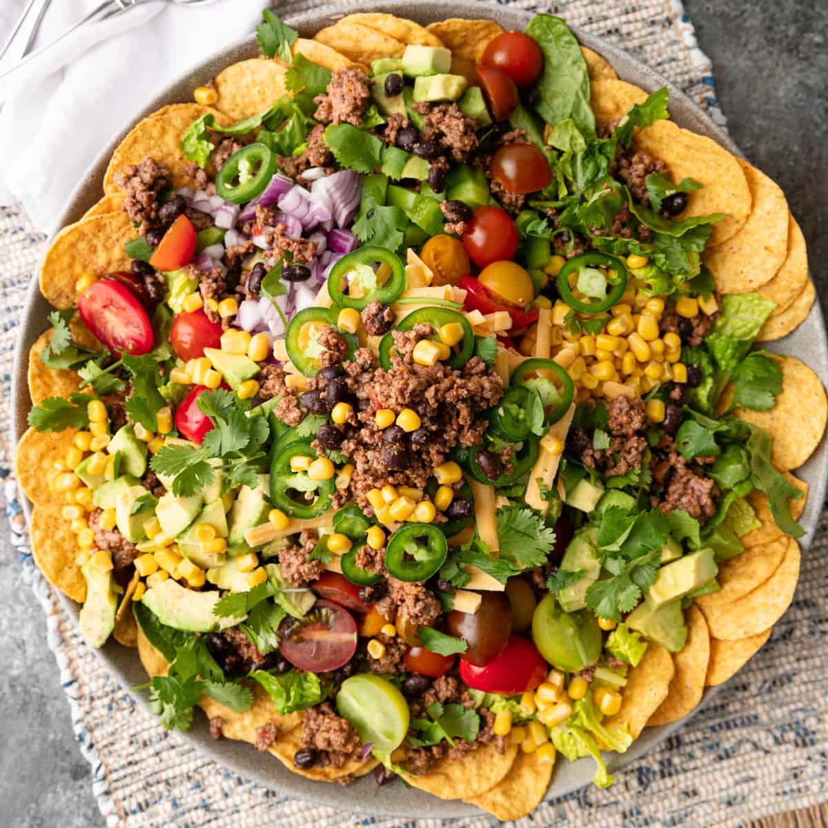 overhead of taco salad recipe surrounded by chips