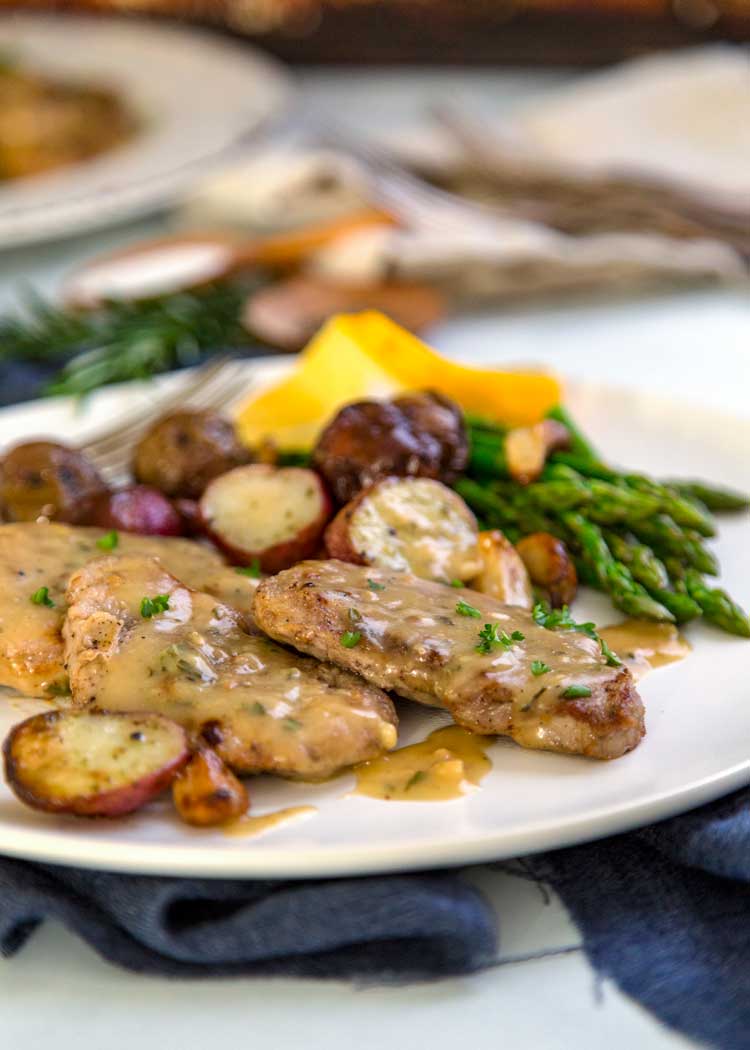 side view of Lemon, Rosemary Pork Medallions on white plate