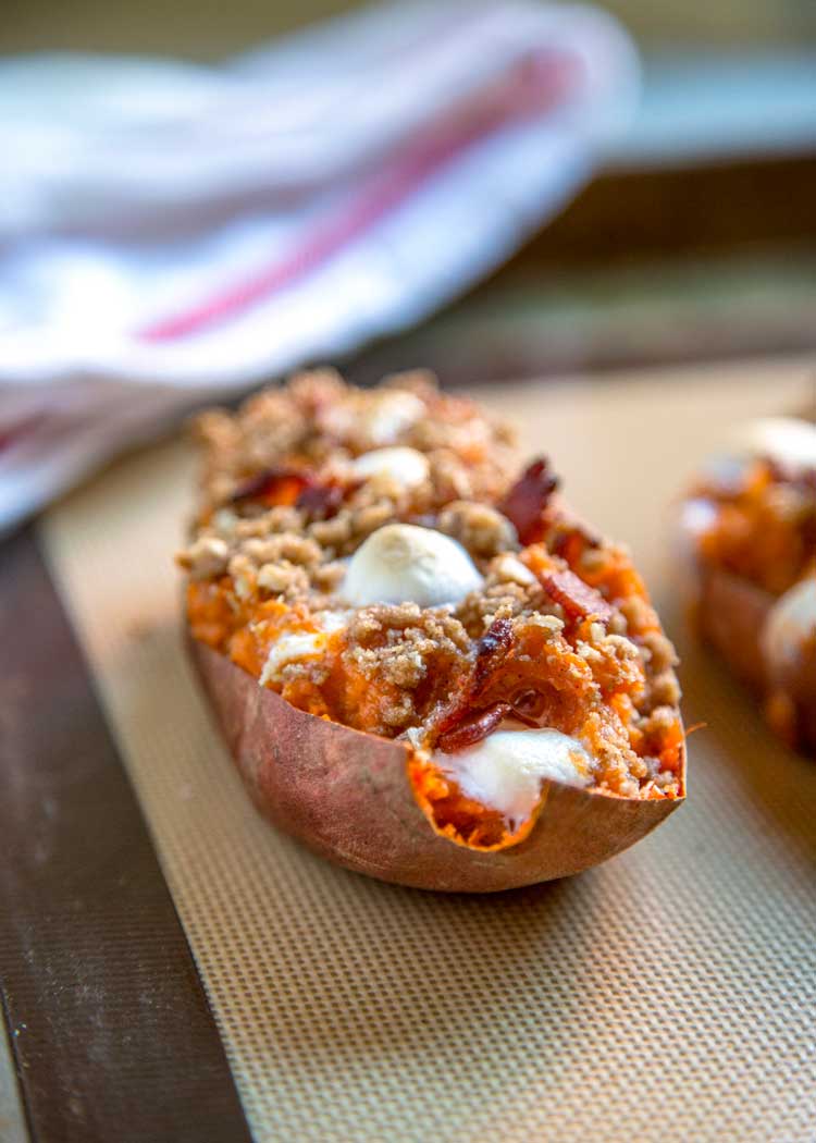 side view close up: twice baked sweet potato with marshmallow, bacon, and sugar topping