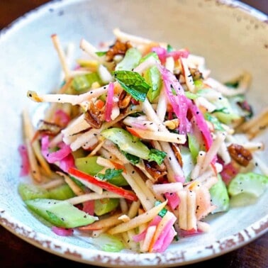 A plate of food on a table, with Apple and Celery