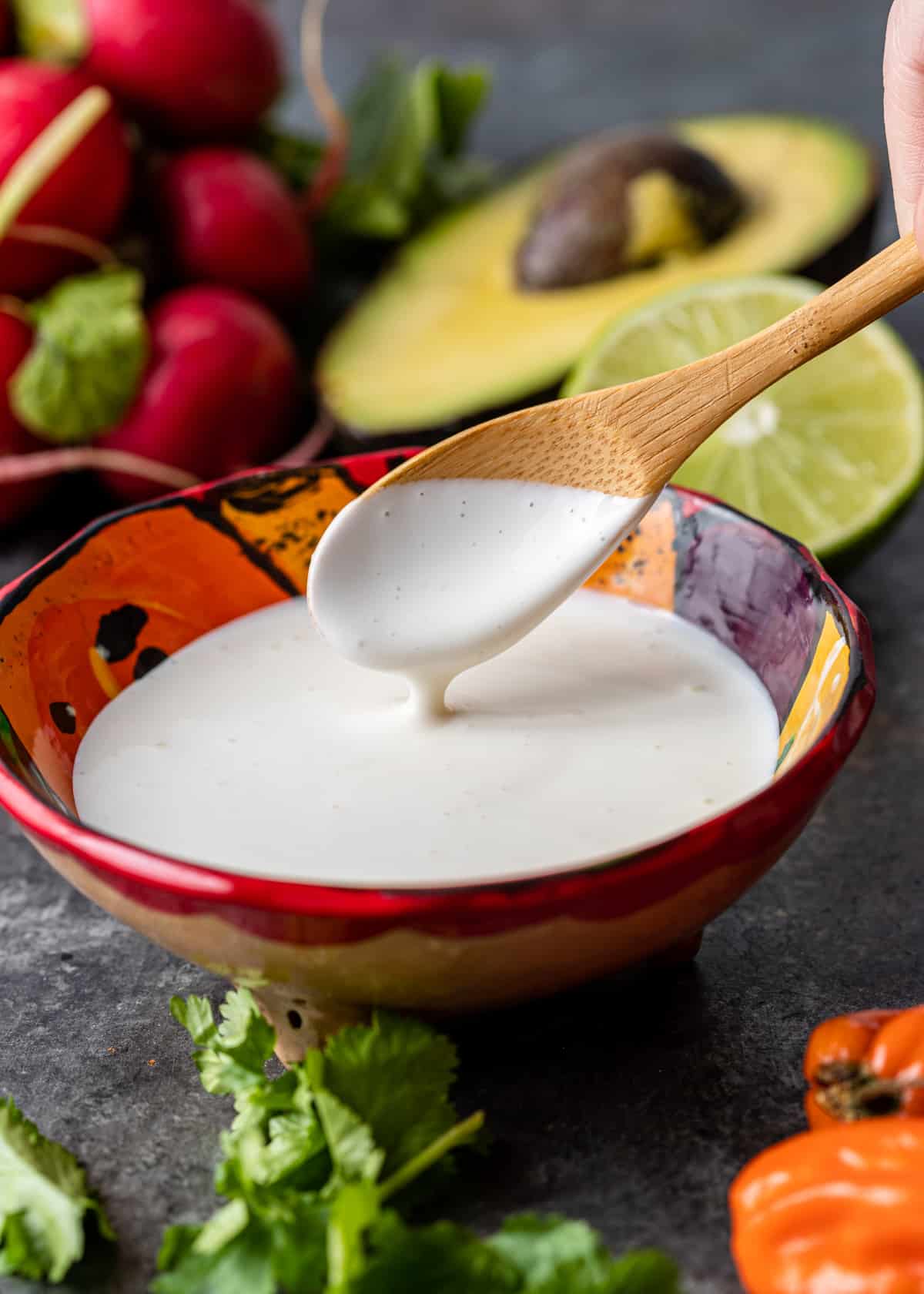 mexican crema in bowl with wooden spoon