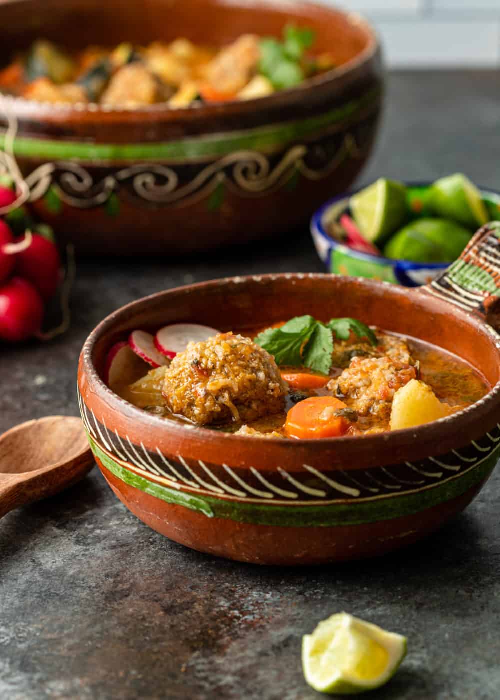 bowl and soup cauldron filled with meatball soup