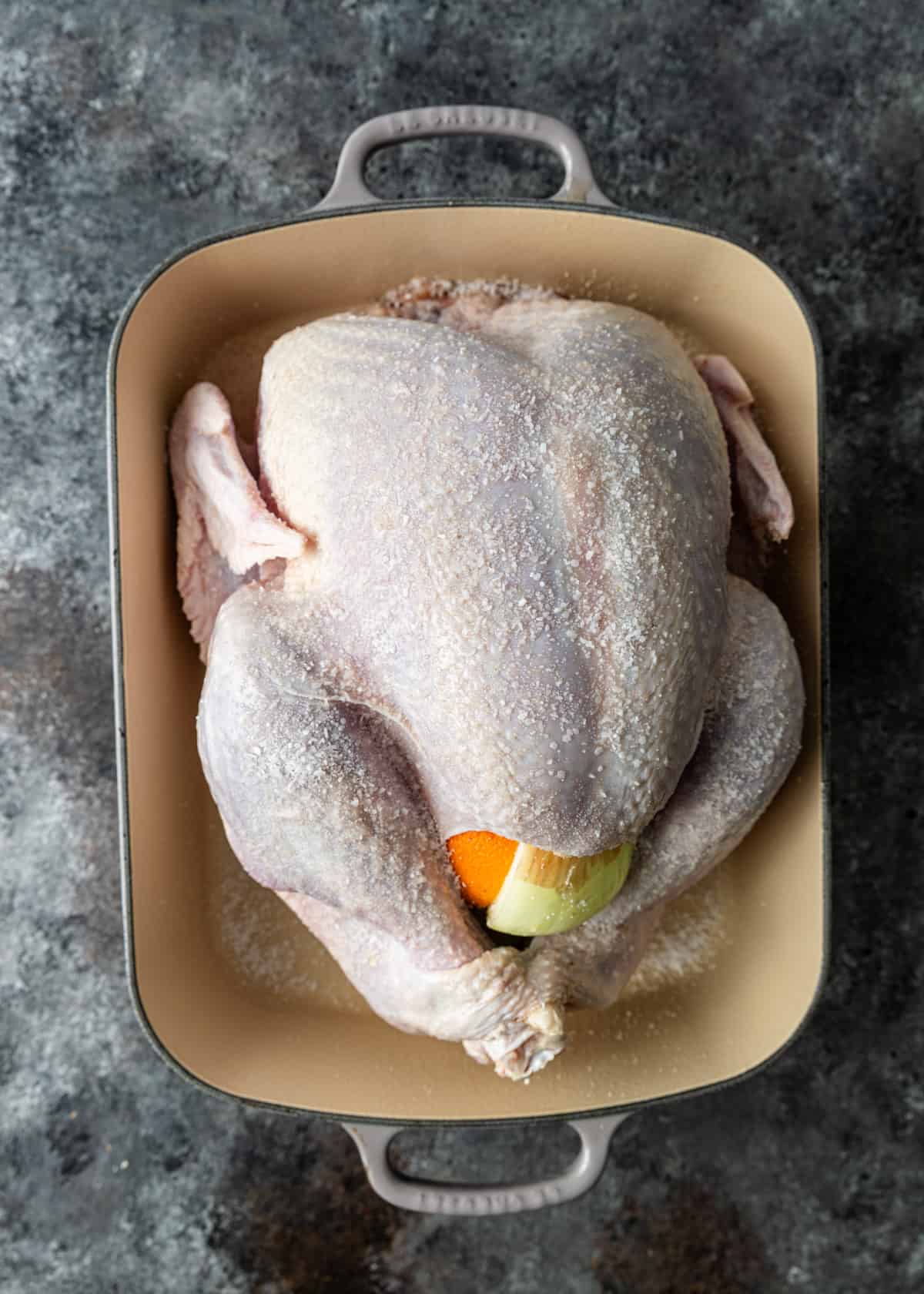 overhead: preparing the raw turkey to roast in a roasting pan