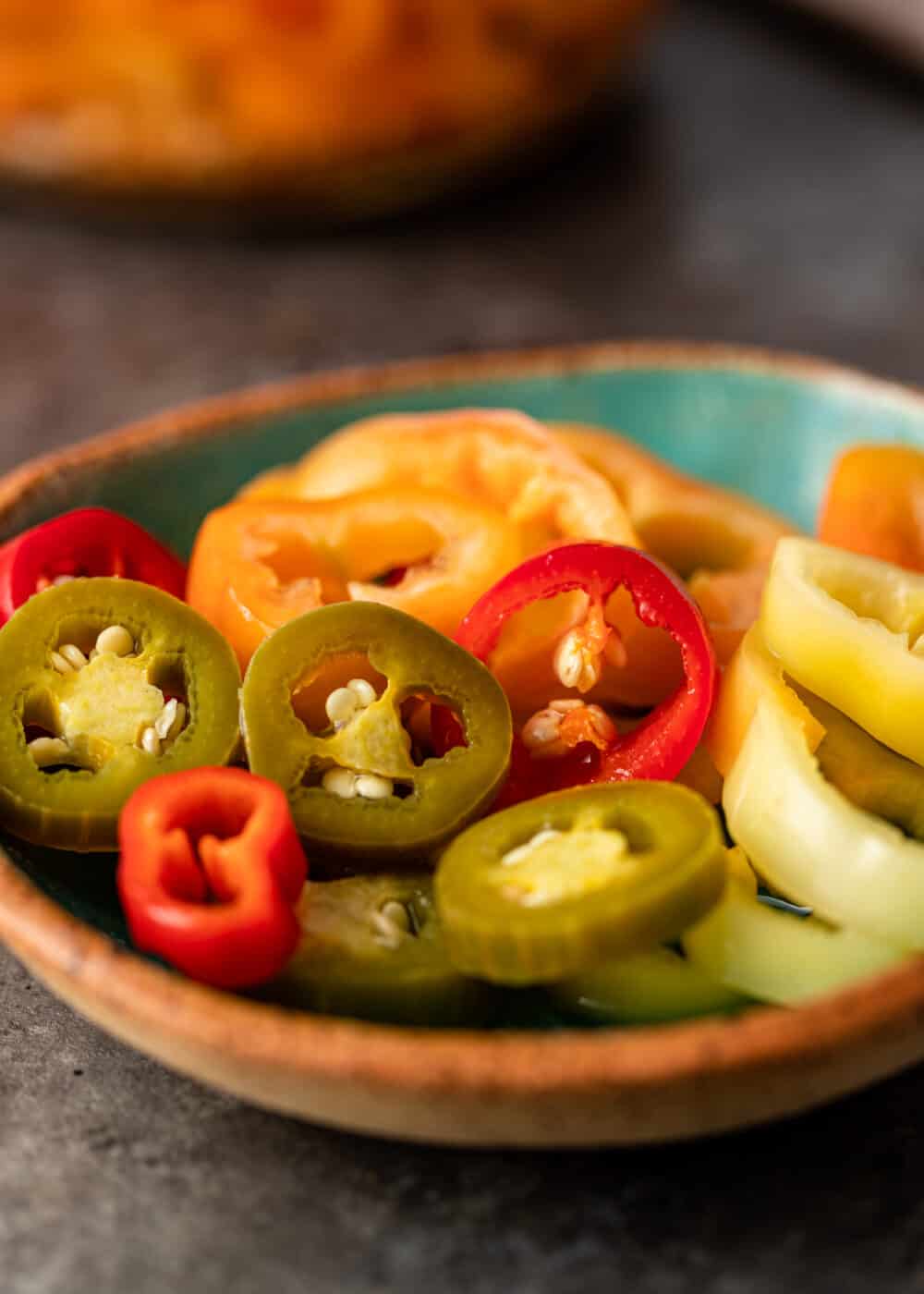 small dish with slices of red, yellow and green chiles