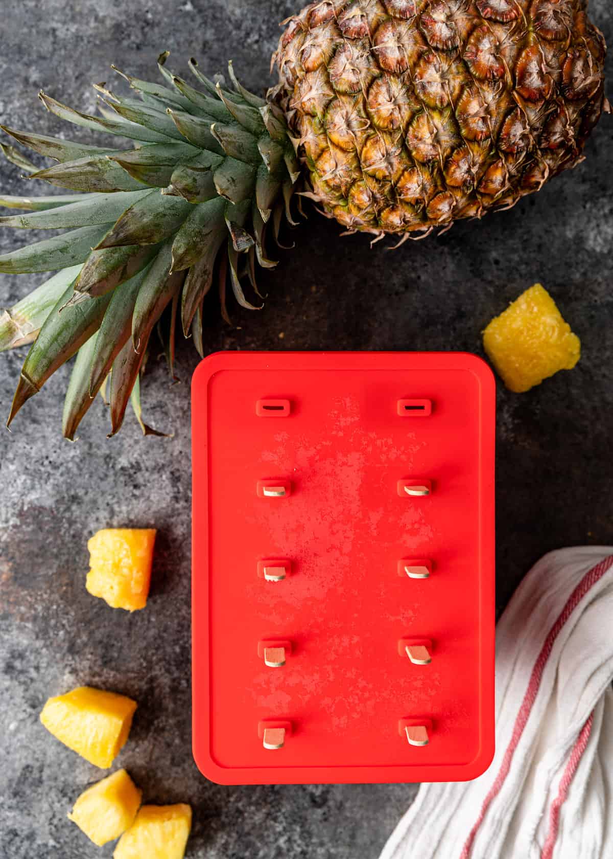 placing wooden sticks into an ice pop mold